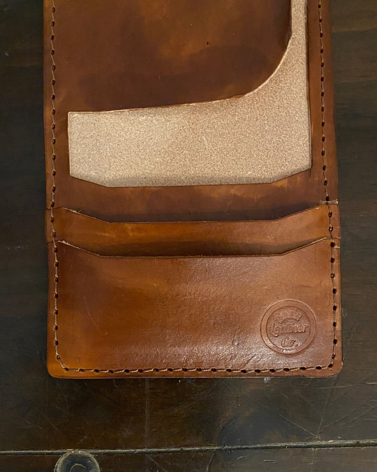 Handmade Buda Leather brown wallet with three card slots, inside flap, and stamped Buda Leather logo.