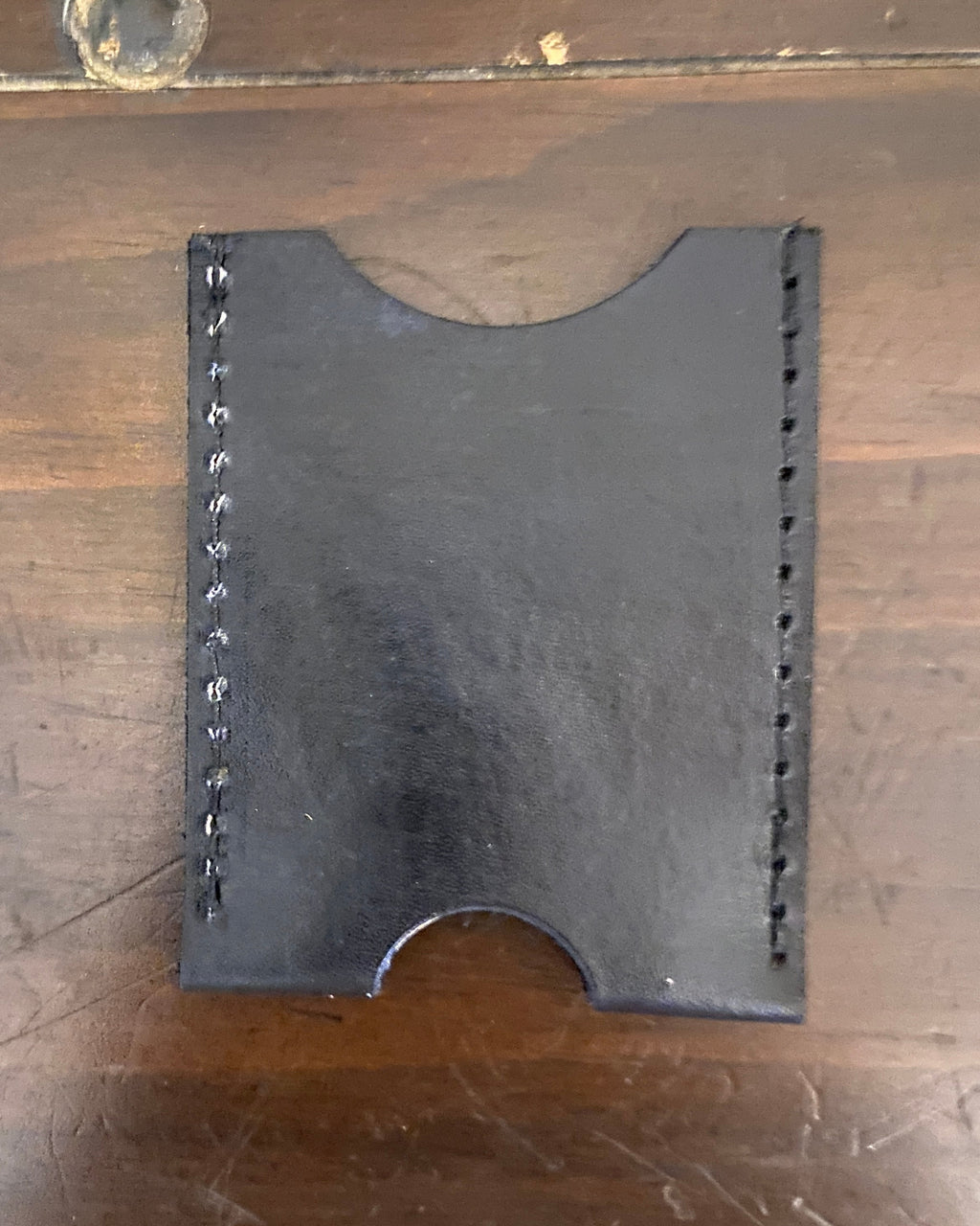 Buda Leather Co. handmade slim leather card wallet with stamped logo, measuring 3.5 inches by 2.5 inches.