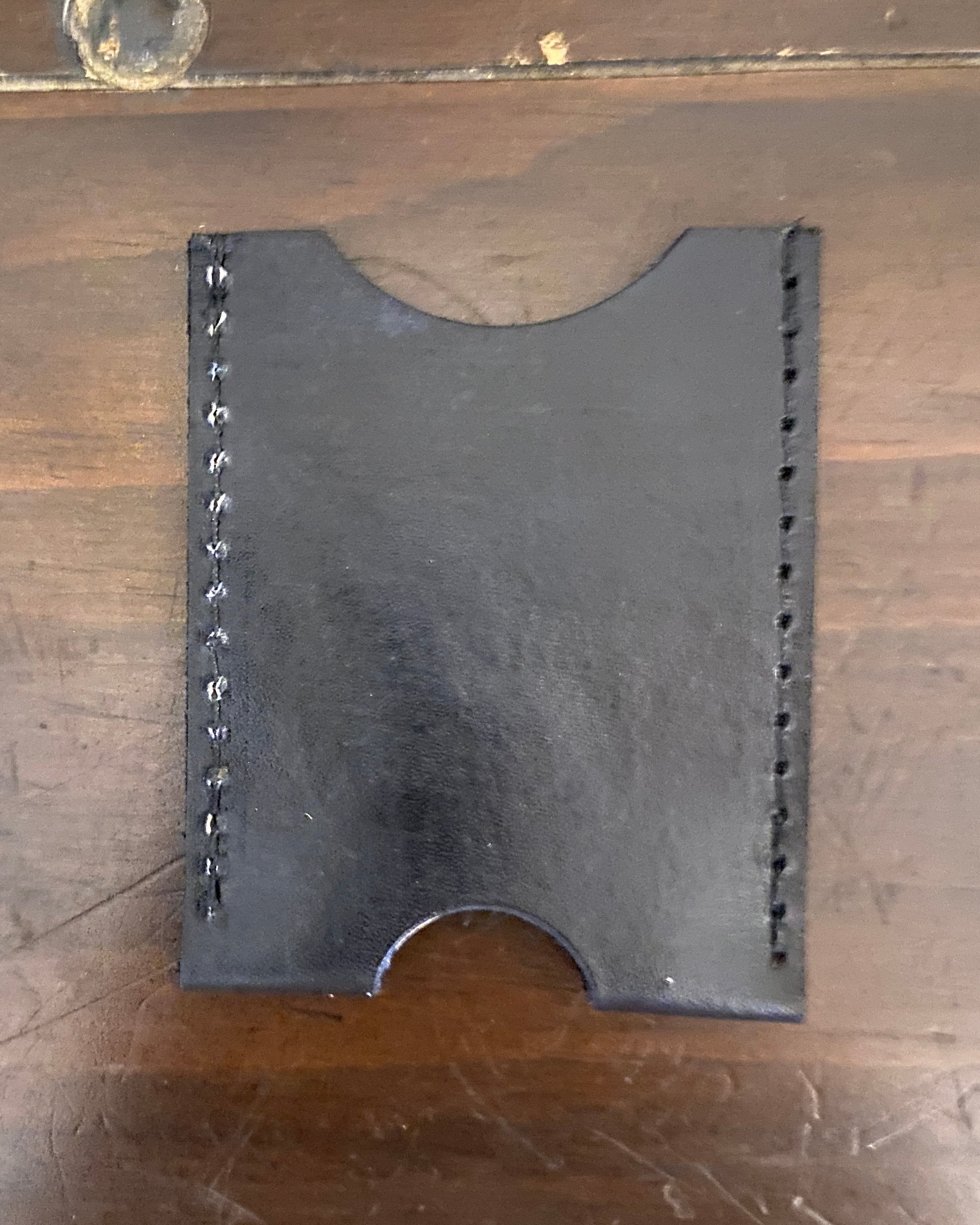 Buda Leather Co. handmade slim leather card wallet with stamped logo, measuring 3.5 inches by 2.5 inches.