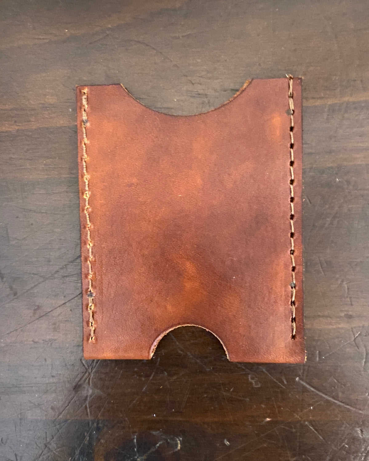 Buda Leather Co. handmade slim leather card wallet with stamped logo, measuring 3.5 inches by 2.5 inches.