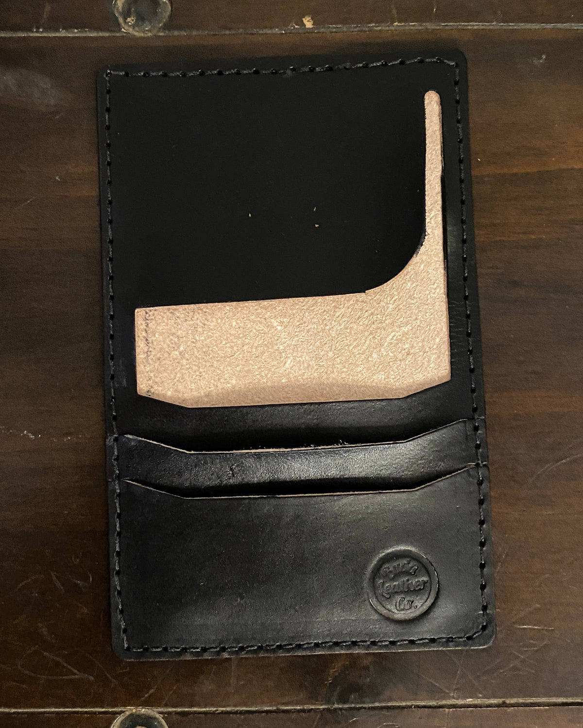 Handmade Buda Leather black wallet with three card slots, inside flap, and stamped Buda Leather logo.