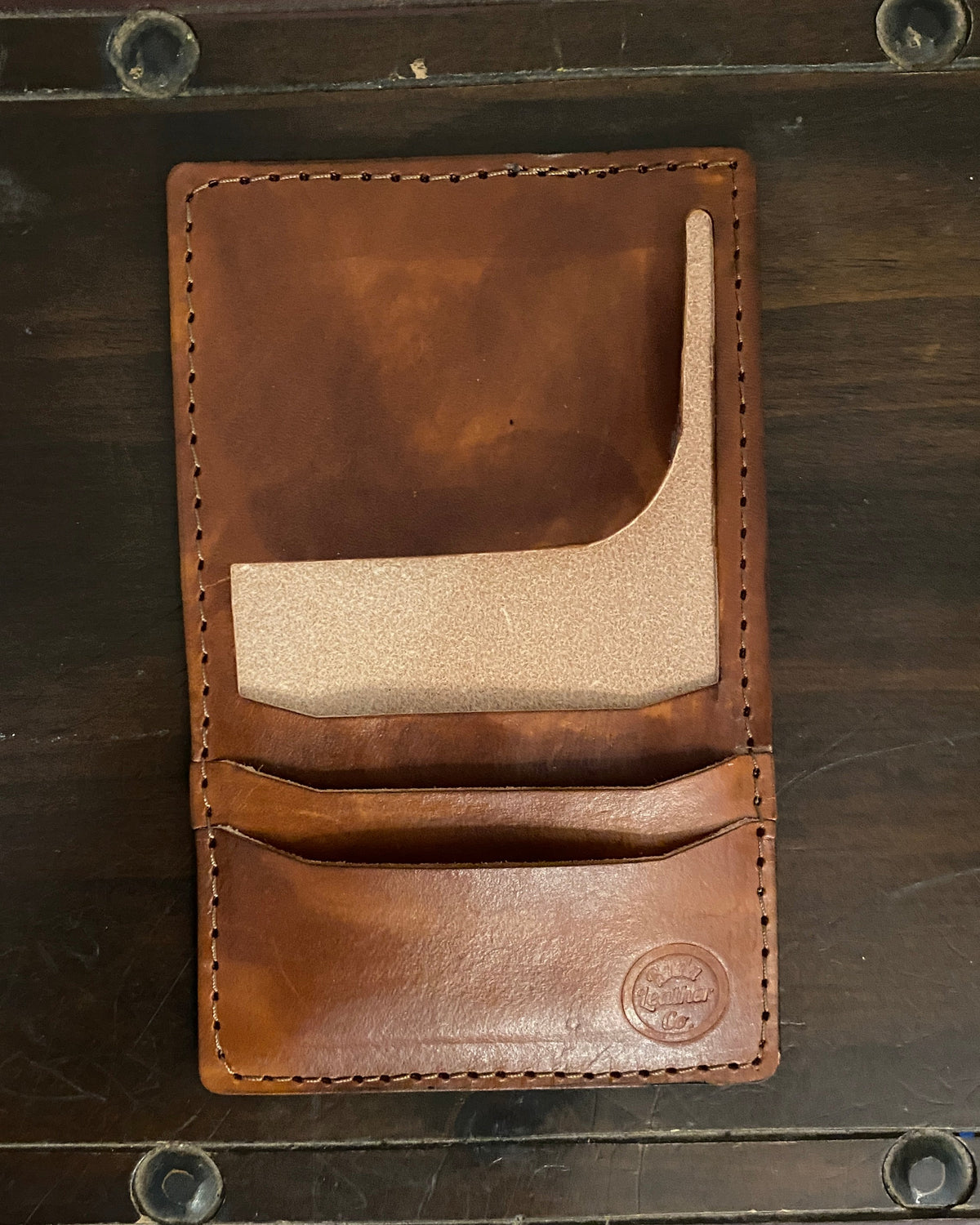 Handmade Buda Leather brown wallet with three card slots, inside flap, and stamped Buda Leather logo.