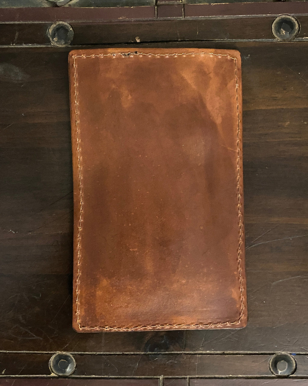 Handmade Buda Leather brown wallet with three card slots, inside flap, and stamped Buda Leather logo.