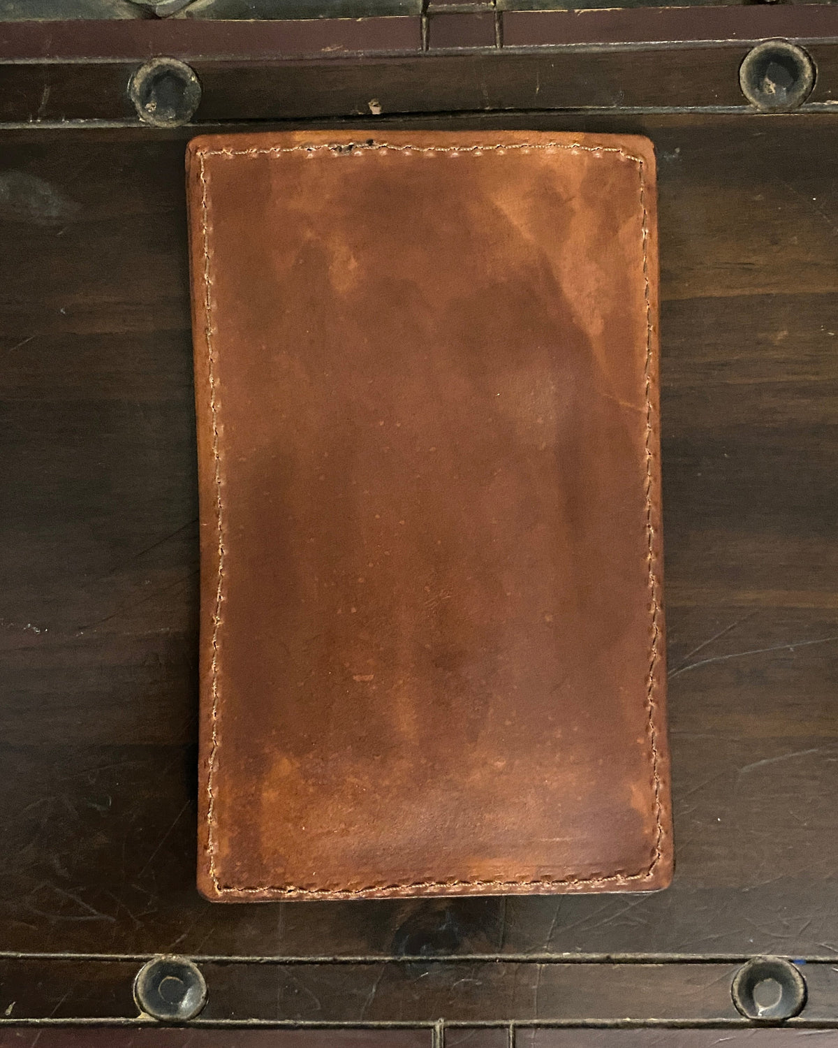 Handmade Buda Leather brown wallet with three card slots, inside flap, and stamped Buda Leather logo.