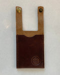 A dark brown leather boot wallet with a lighter tan leather top section and two brass snap buttons, featuring a debossed 'Buda Leather Co' logo on the bottom right.