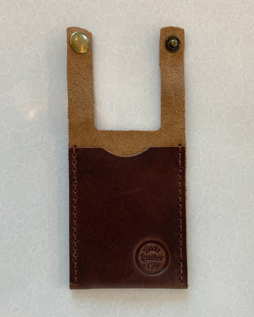 A dark brown leather boot wallet with a lighter tan leather top section and two brass snap buttons, featuring a debossed 'Buda Leather Co' logo on the bottom right.